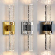 Modern bubble crystal led wall sconces with clear cylindrical glass and metallic gold silver or black mounts for bathroom mirrors