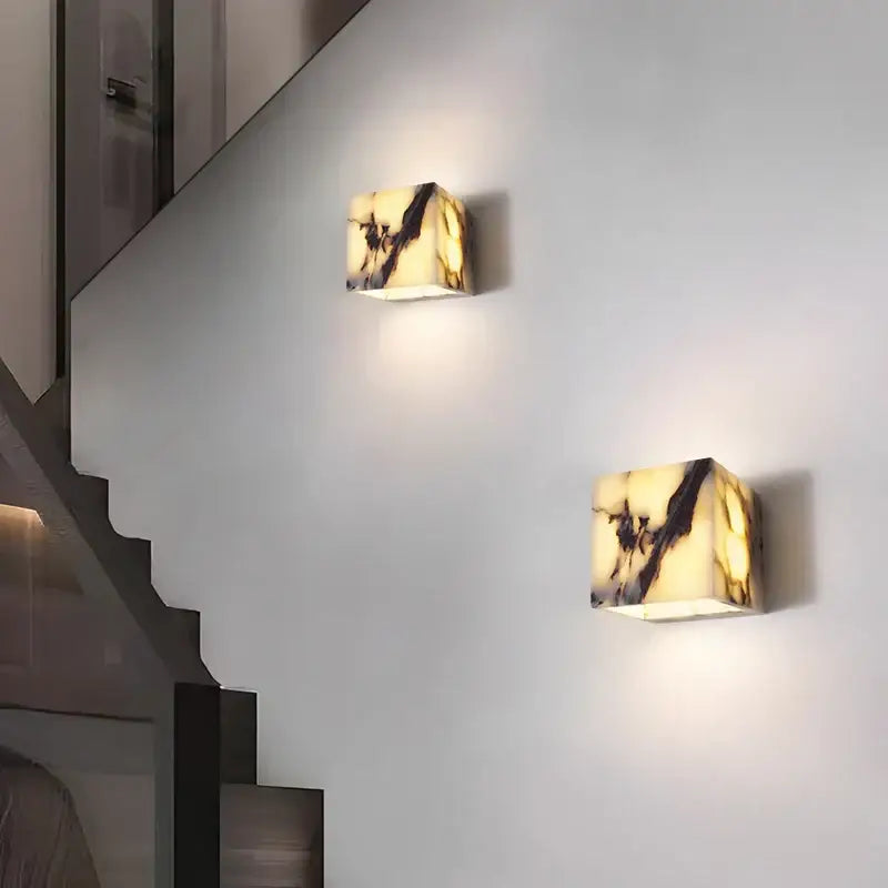 Two polished onyx square wall lights with warm creamy yellow alabaster base and dark veining from decorbites bulgari stone led collection