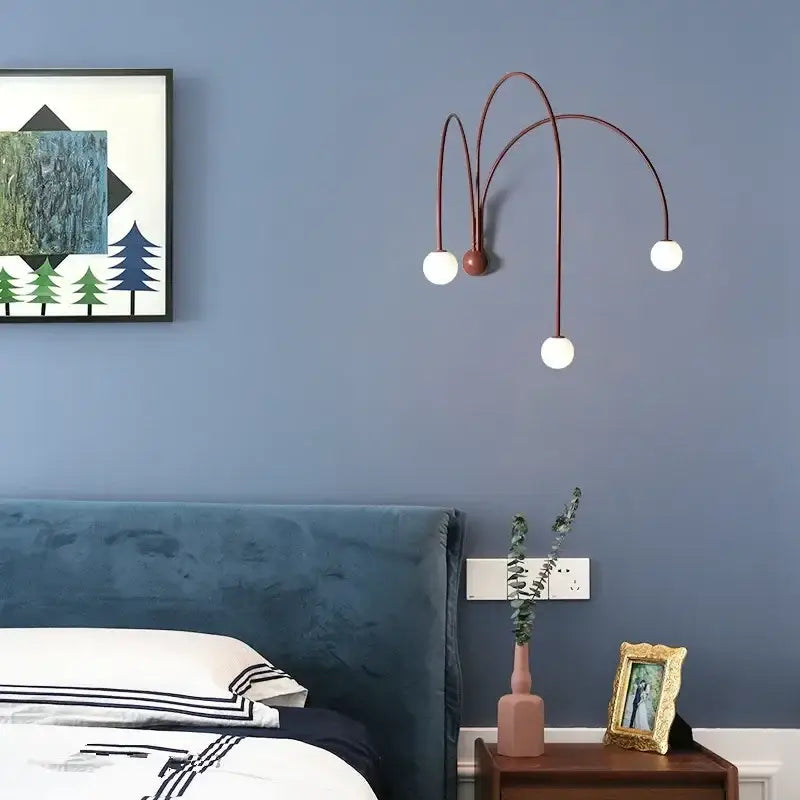 Modern burgundy iron glass led wall light with copper-toned sconce, three curved arms, and white spherical bulbs for living room decorbites iron glass