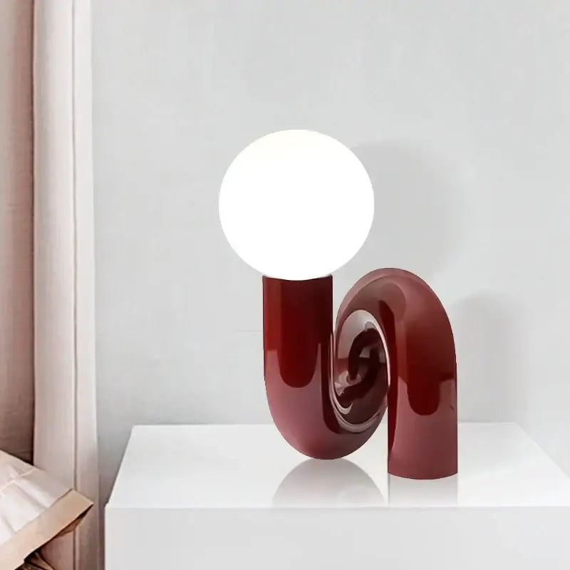 Modern burgundy and white decorbites glass ball table lamp with glossy curved base for stylish bedroom decor
