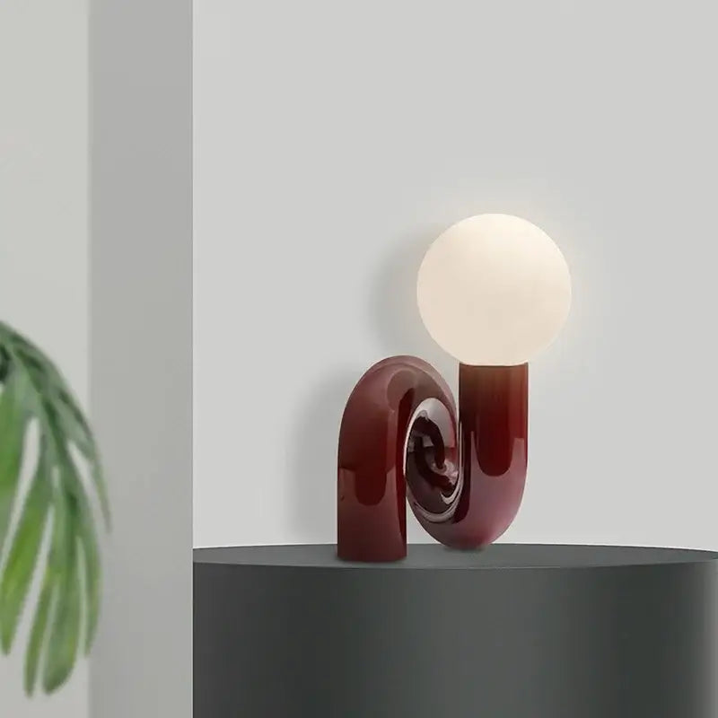 Modern burgundy and white glass ball table lamp with a sculpted spiral base perfect for bedroom decorbites glass ball decor