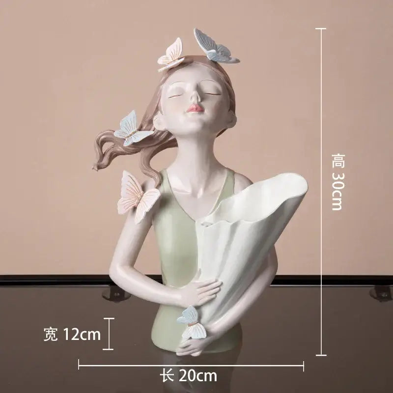 Delicate butterfly girl resin sculpture featuring a woman with closed eyes holding a white fan adorned with pastel butterflies