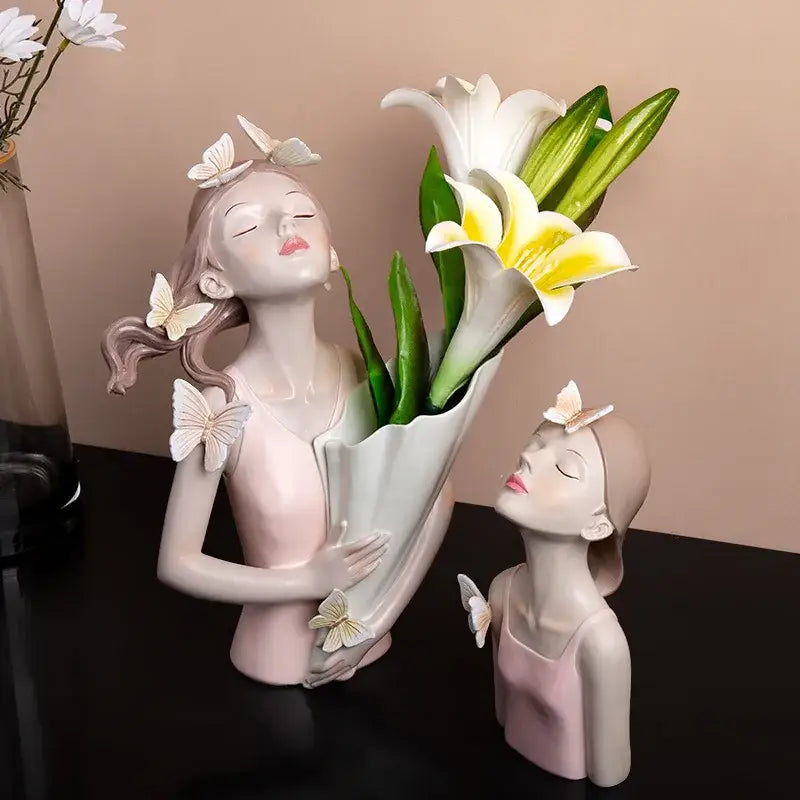 Modern butterfly girl resin sculpture in pink and white featuring a woman with lilies and butterfly girl resin details
