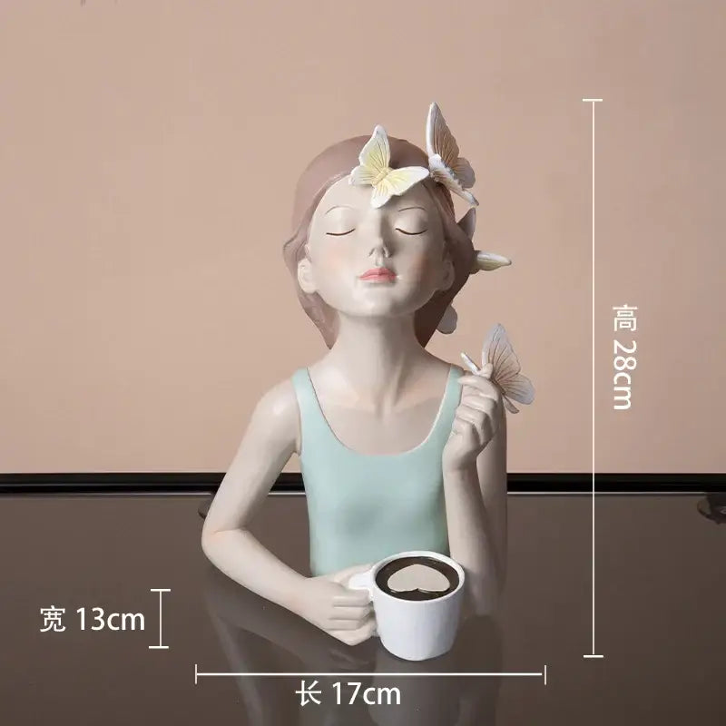 A serene light blue butterfly girl resin sculpture holding a white mug for modern living room decor
