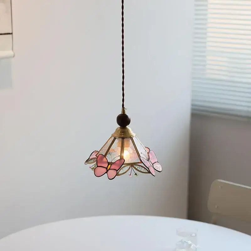 Modern butterfly pink led pendant lamp featuring a delicate stained glass butterfly pink decorbites design with brass accents