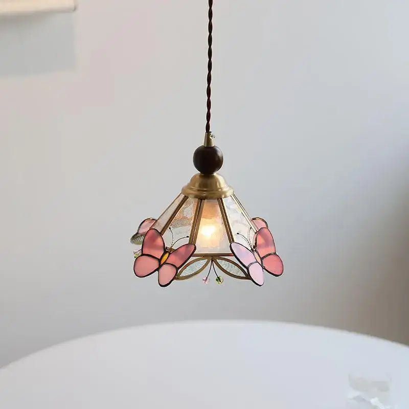 Modern butterfly pink led pendant lamp featuring stained glass with brass accents and twisted brown cord decorbites butterfly pink