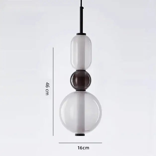 Modern candy glass ceiling chandelier with three stacked translucent white and dark brown glass orbs on black rod