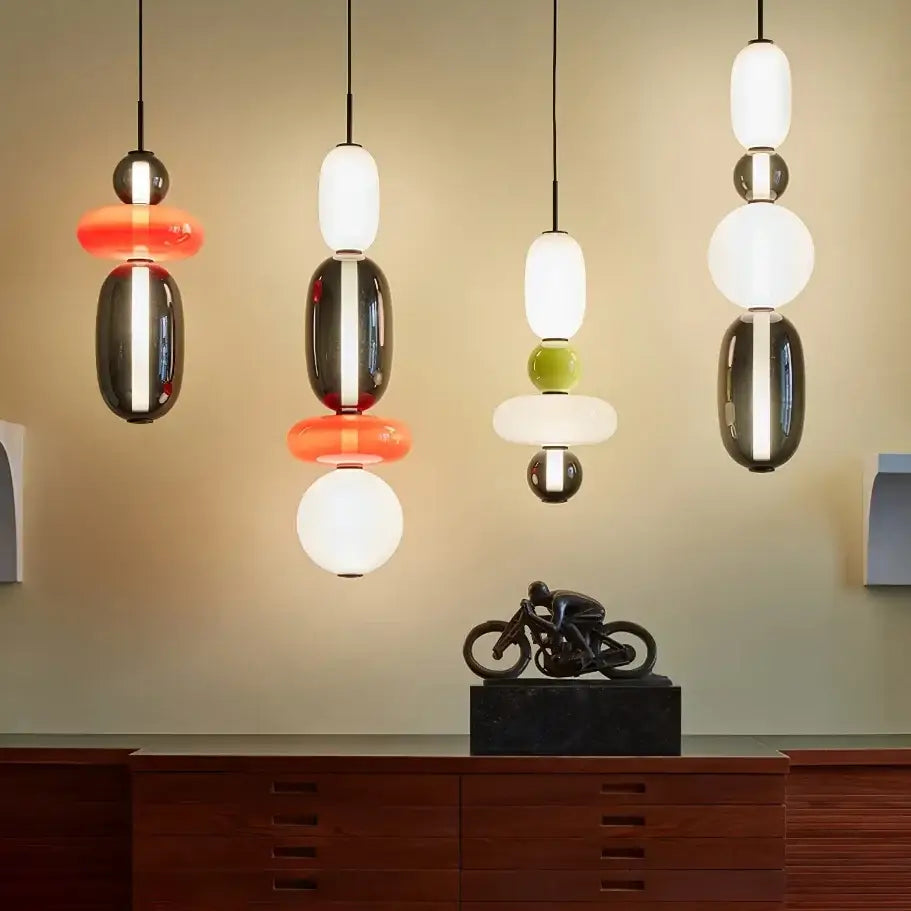 Modern candy glass ceiling chandelier with stacked glossy glass and metallic spheres in black white orange and green hues