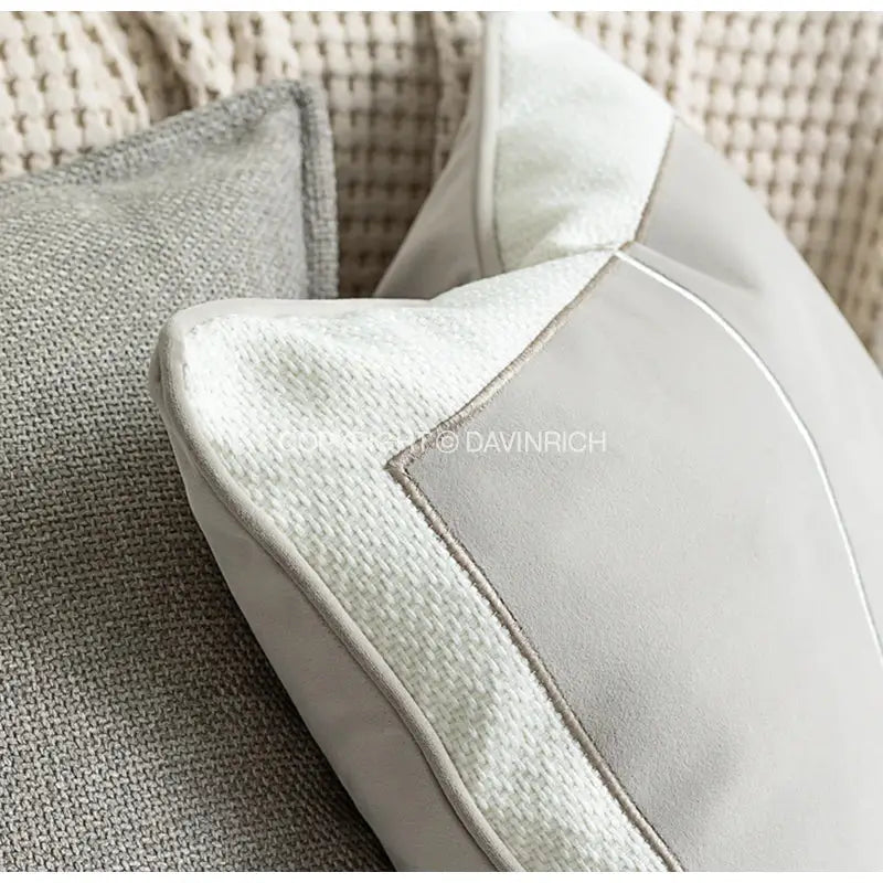Modern gray cushion with textured weave and smooth suede panel featuring tone geometry embroidery in cappuccino tone decorbites style