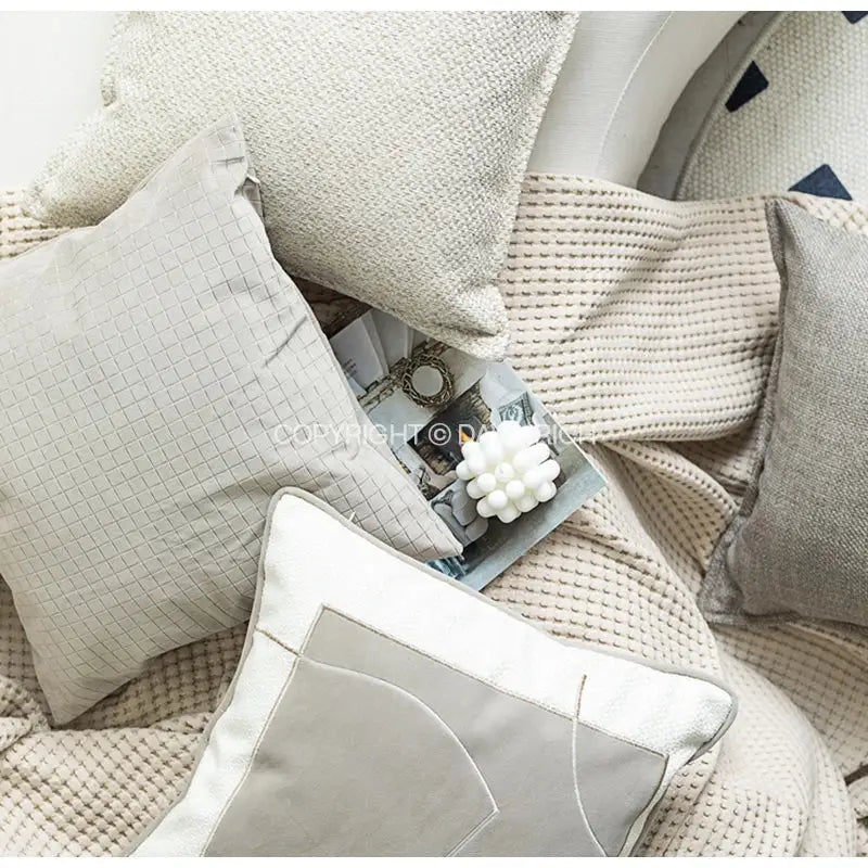 Beige textured throw pillow with subtle grid pattern and white piping featuring decorbites cappuccino tone geometry embroidery