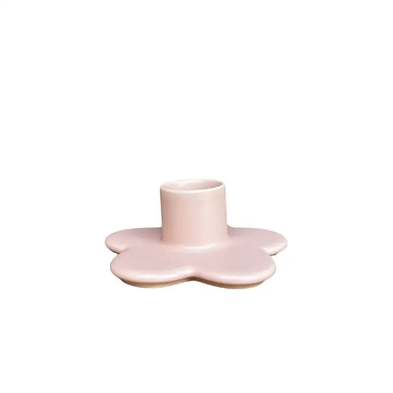 Pastel pink ceramic candle holder shaped like a five-petaled cartoon flower for modern bedroom decorbites cartoon flower decor