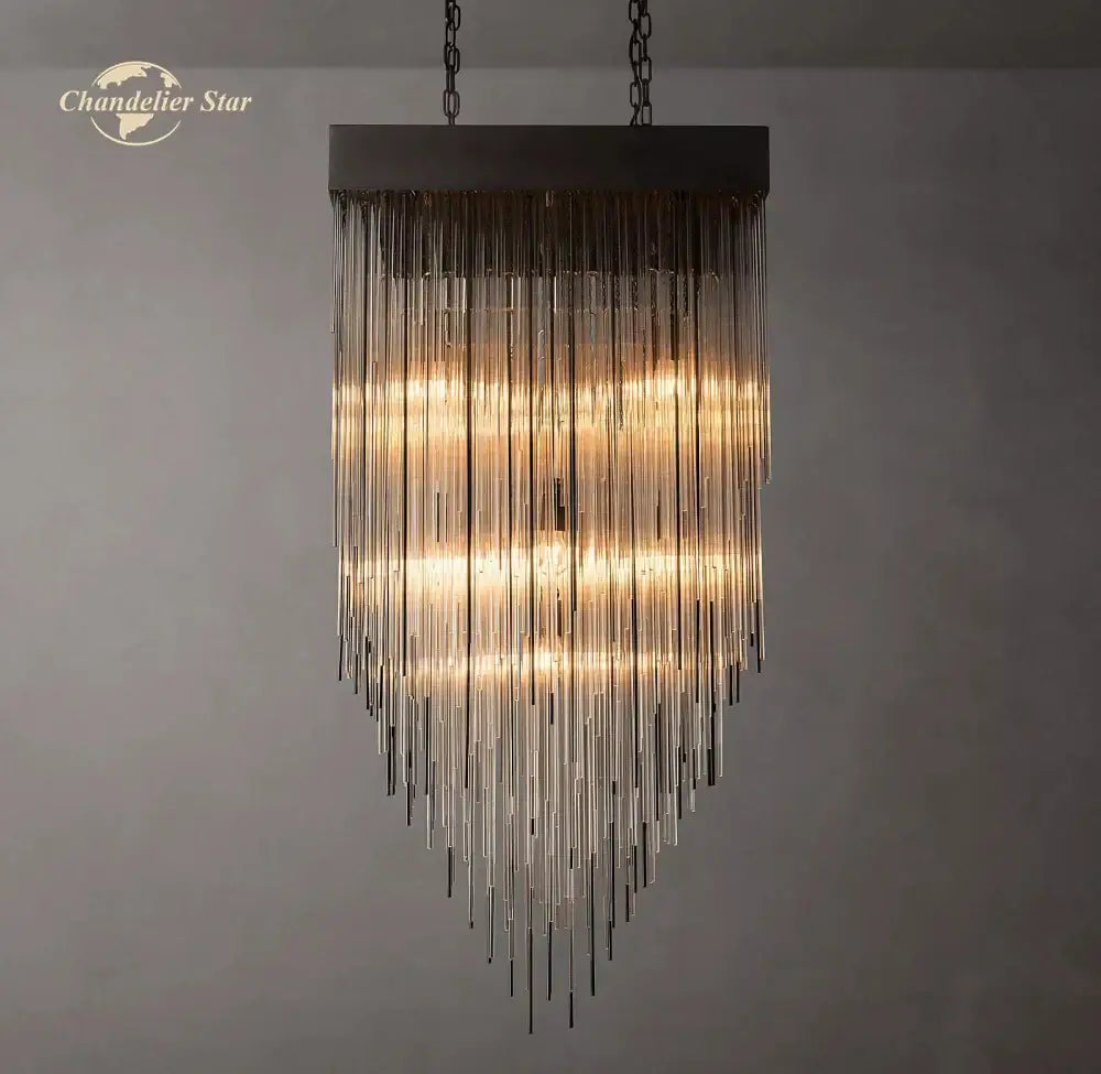 Modern cascada led glass chandelier with dark metal frame and cascading clear tubes creating warm amber light decorbites cascada led