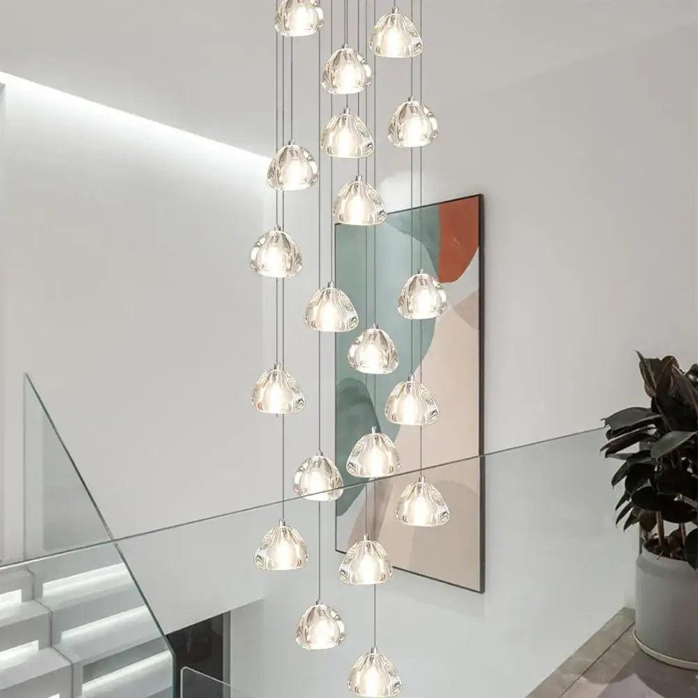 A modern decorbites crystal ball chandelier with clear teardrop glass pendants hanging from thin metallic chains