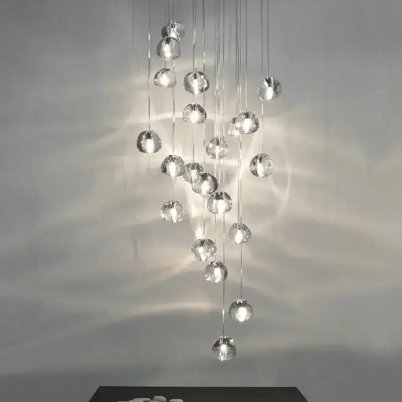 A modern decorbites crystal ball chandelier with clear glass orbs suspended by thin metallic chains for living rooms