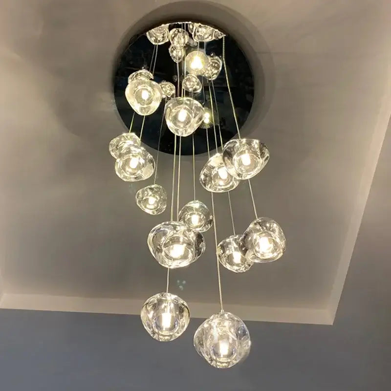 A modern decorbites crystal ball chandelier with clear glass globes suspended from a circular ceiling mount for living room
