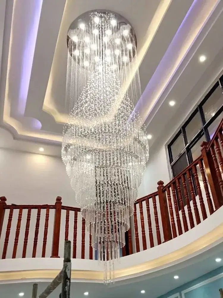 A modern cascading decorbites crystal chandelier with clear glass beads and embedded lights for living room use