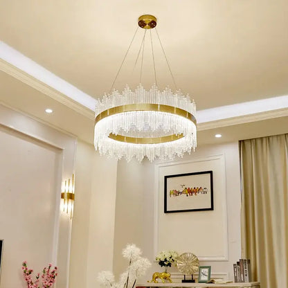 Modern gold-toned crystal pendant chandelier with clear prisms hanging from a circular frame for dining room decorbites crystal pendant