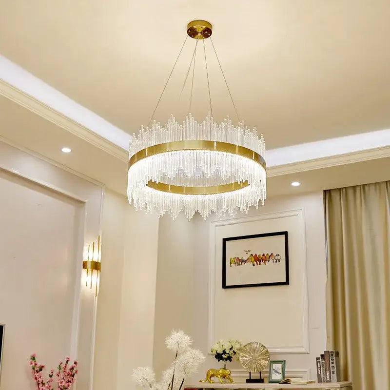Modern gold-toned crystal pendant chandelier with clear prisms hanging from a circular frame for dining room decorbites crystal pendant