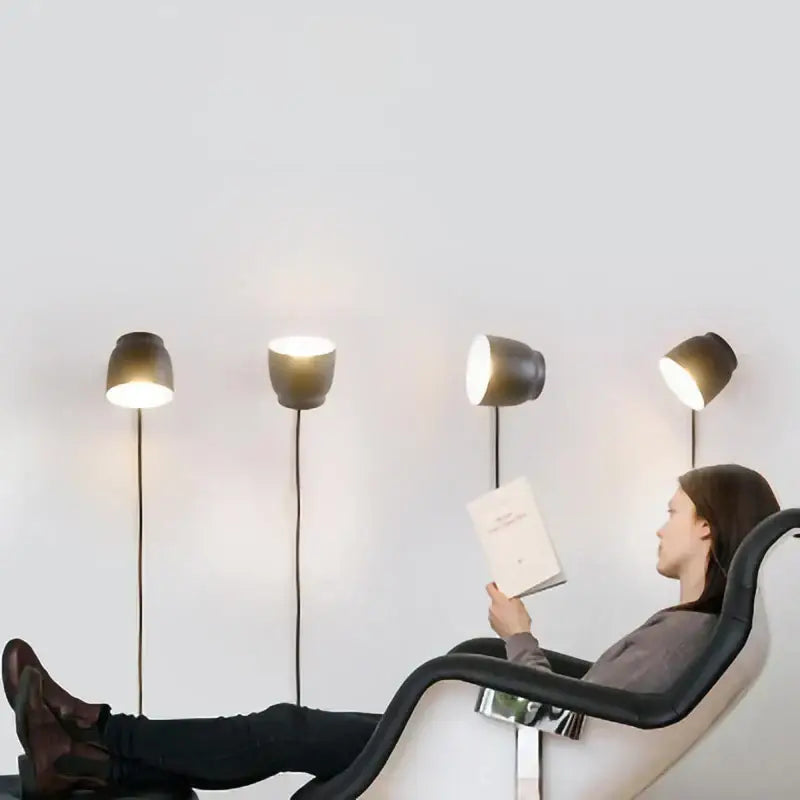 Modern ceramic and wood led wall lamp with a sleek matte black cylindrical shade for bedroom reading light