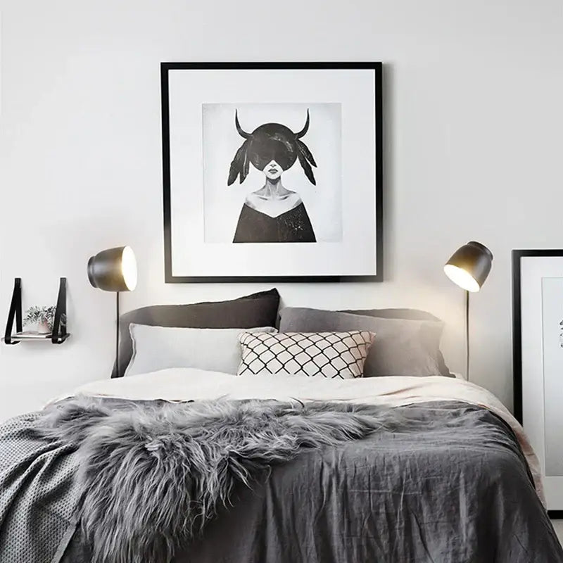Black-framed led wall lamp with modern ceramic and wood design featuring monochrome woman illustration with horned headwear