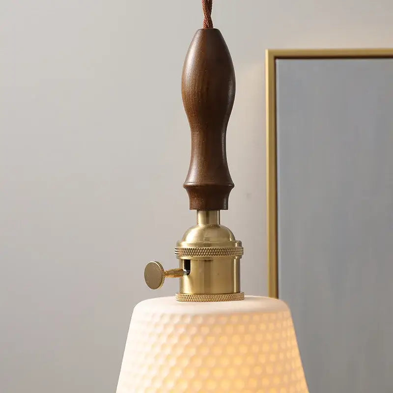 Modern ceramic led pendant light with warm-toned off-white glass shade and dark wood handle for dining room decorbites ceramic led