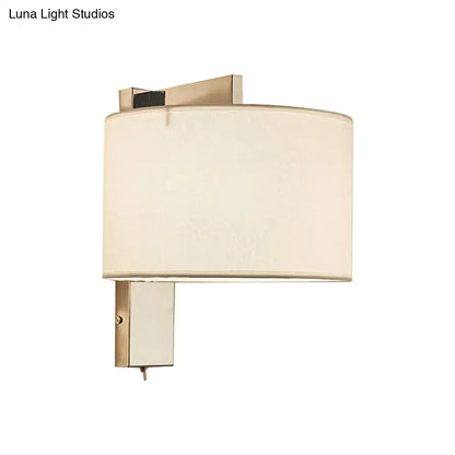 Modern brushed brass wall sconce with cylindrical off-white fabric shade for white black drum wall sconce lighting