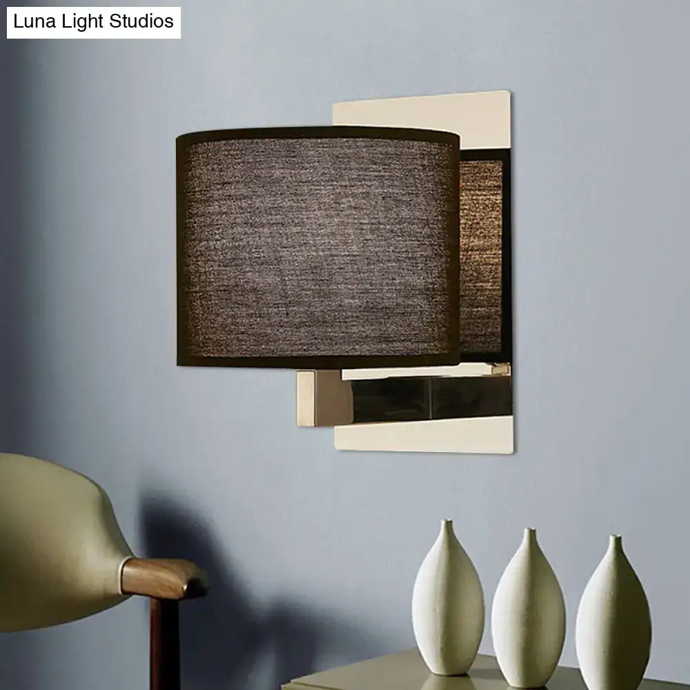 Modern charcoal fabric drum wall sconce with white black geometric metal frame in cream and brushed brass finish for bedroom light