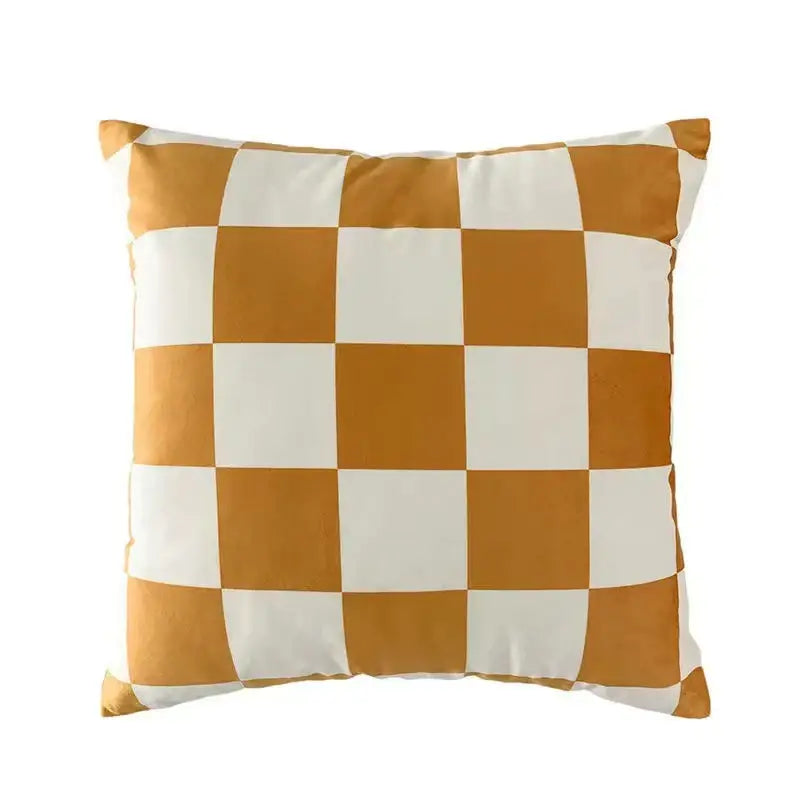 A modern checkered cushion cover in bold orange and white made of decorbites fluffy velvet for bedroom decor