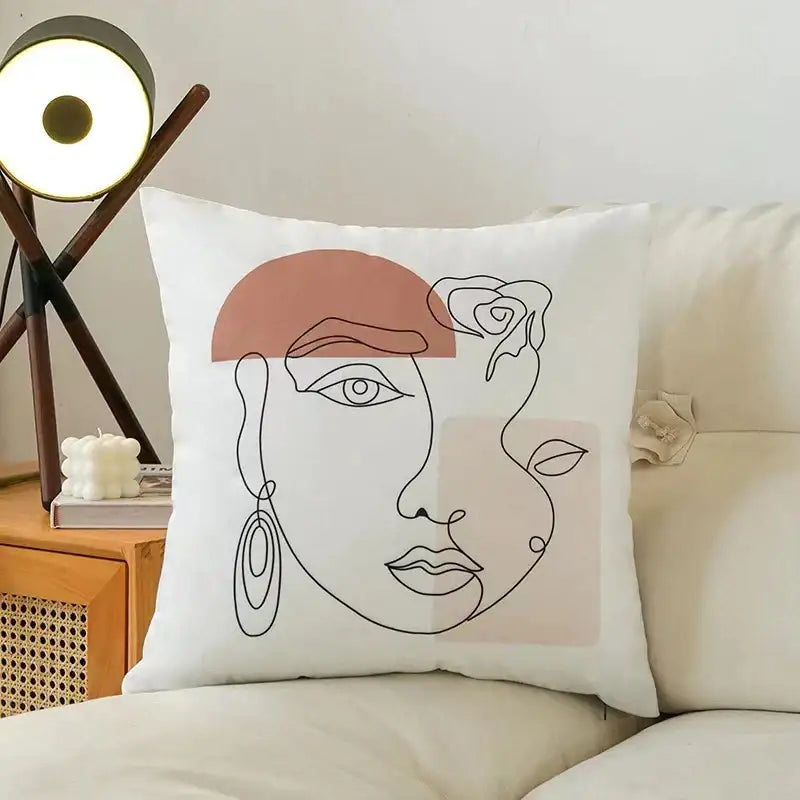 White throw pillow with minimalist line-art face and blush pink beige accents on decorbites fluffy velvet cushion cover