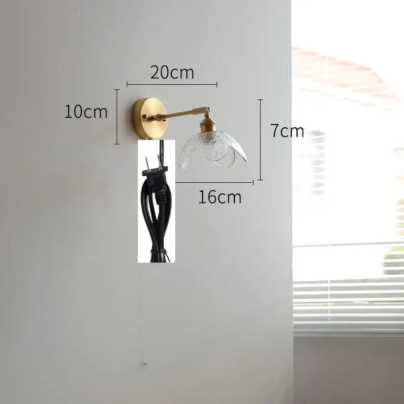 Gold-toned wall light with clear textured glass shade featuring a green glass led bedroom pull chain switch design