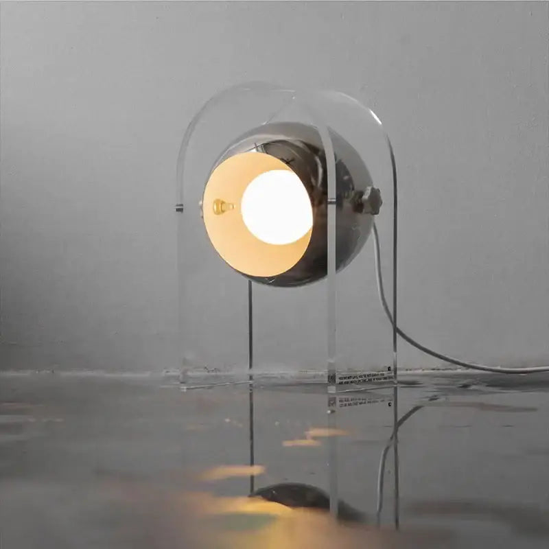 Modern chrome acrylic led desk lamp with spherical chrome head and transparent frame emitting warm light for bedroom decorbites acrylic led