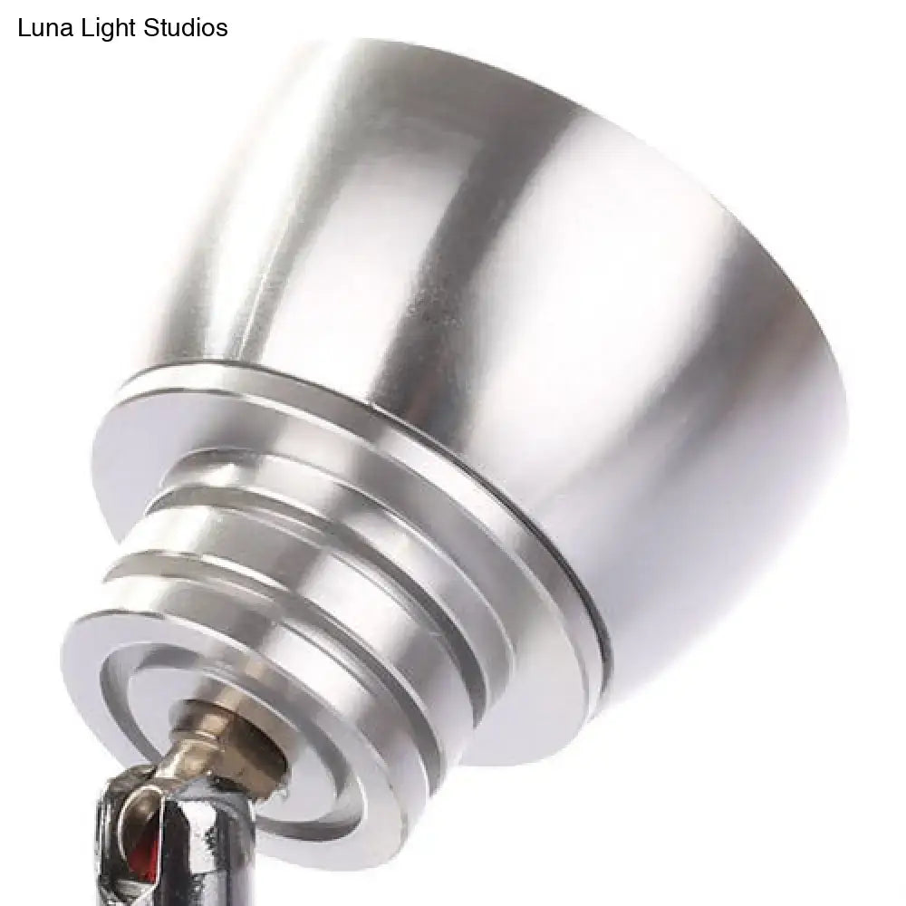 Modern chrome adjustable spotlight wall sconce with shiny metal shade and warm white light for bedroom use