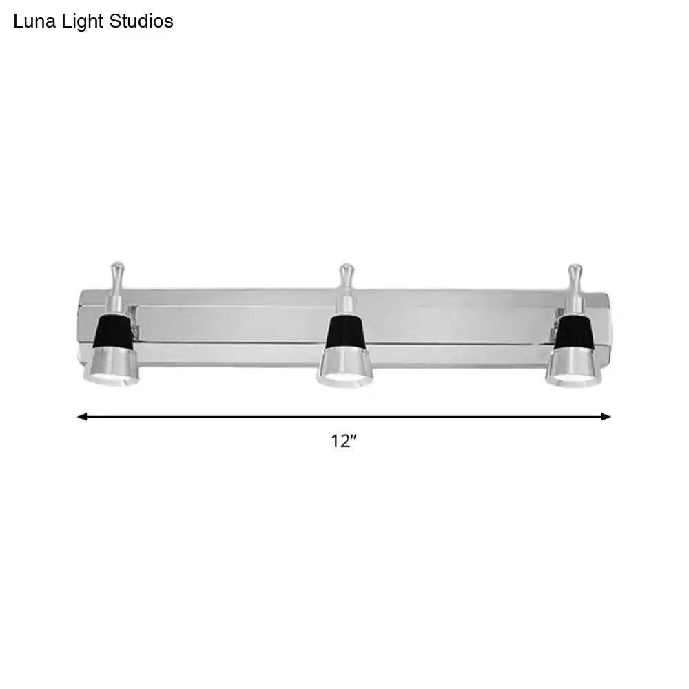 Modern chrome adjustable wall lamp with three lights and black accents on lamp shades for bathroom use