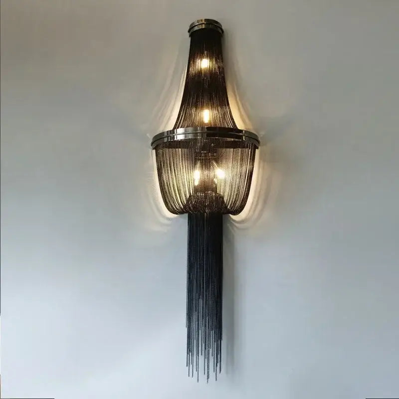 Elegant black metal aluminum chain sconce with sleek tiered design and warm glowing lights for bedroom wall lighting