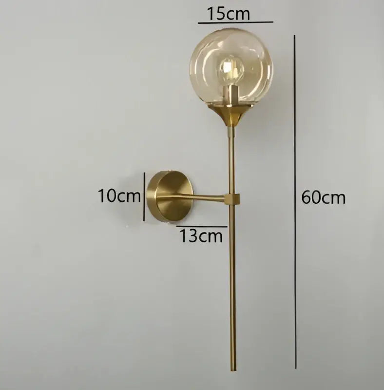 Modern brass-finished wall lamps with amber glass ball and exposed filament bulb for stylish living room decorbites lighting