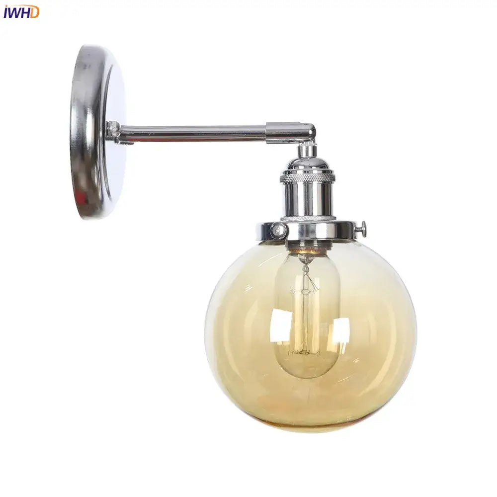 Modern chrome and amber glass ball wall light with spherical globe and exposed filament bulb for bedroom sconce