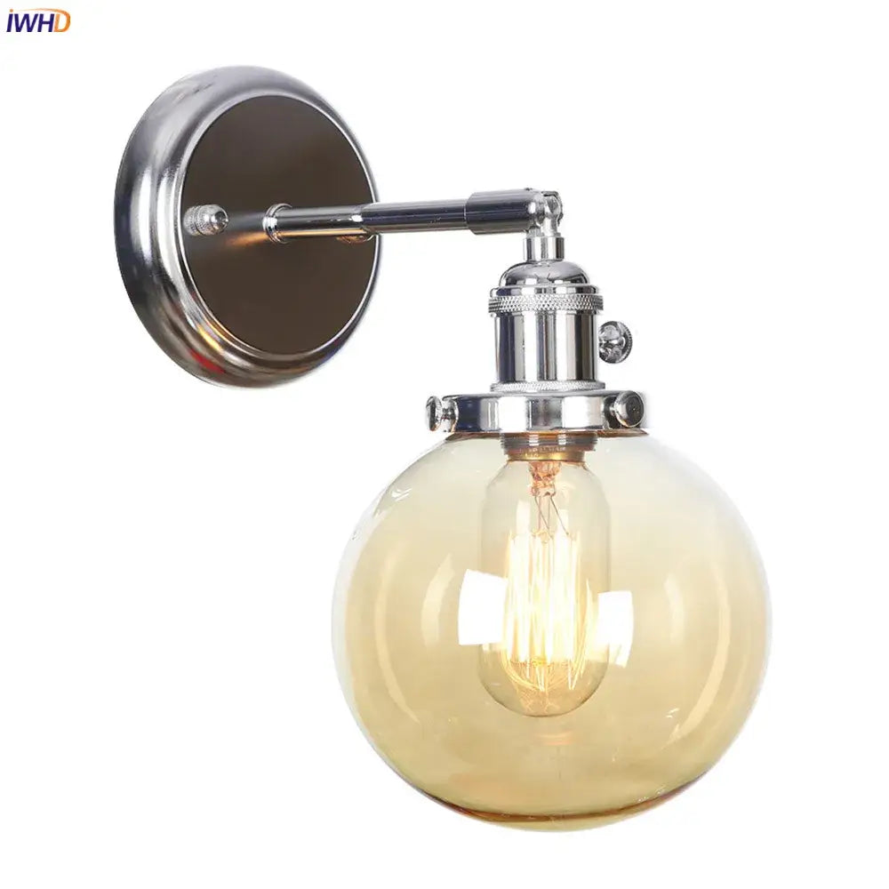 Modern chrome and amber glass ball wall light with spherical amber glass globe and exposed filament bulb for bedroom sconce