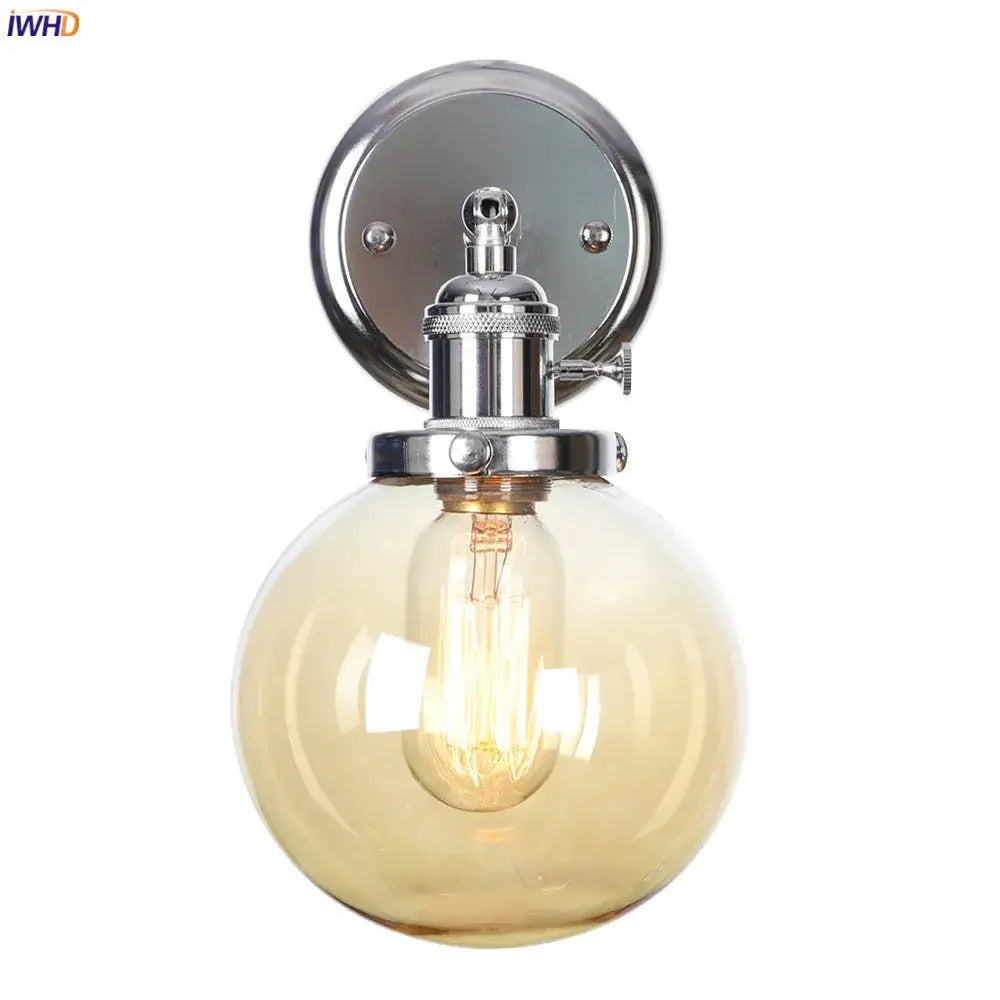 Modern chrome and amber glass ball wall light with spherical amber glass globe and exposed filament bulb for bedroom sconce