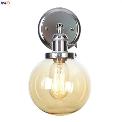 Modern chrome and amber glass ball wall light with spherical amber glass globe and exposed filament bulb for bedroom sconce