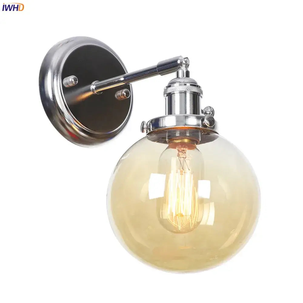 Modern chrome wall light with amber glass ball and exposed filament bulb for bedroom sconce lighting
