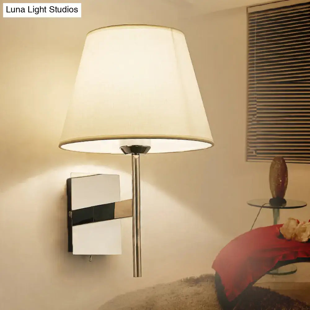 Modern chrome and beige fabric cone wall light with sleek chrome finish and off-white fabric shade for bedroom sconce