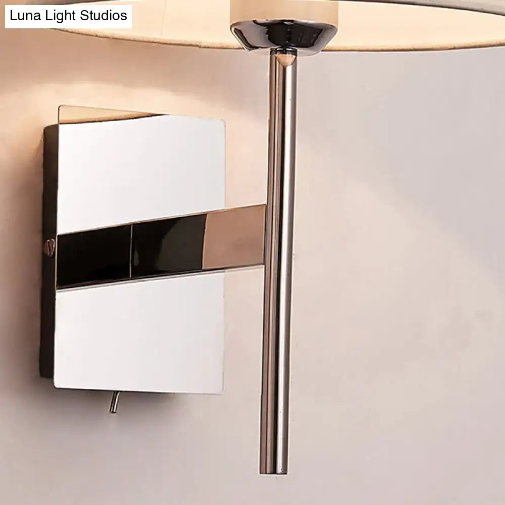 Modern wall light with sleek chrome finish and geometric white and black panels for stylish bedroom lighting