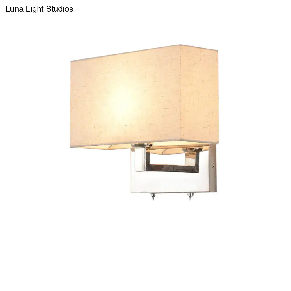 Modern wall light with a beige fabric shade and polished chrome frame, rectangular design ideal for bedroom use