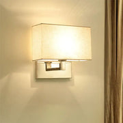 Modern wall light with sleek chrome finish and soft beige fabric shade measuring inches high and shade width
