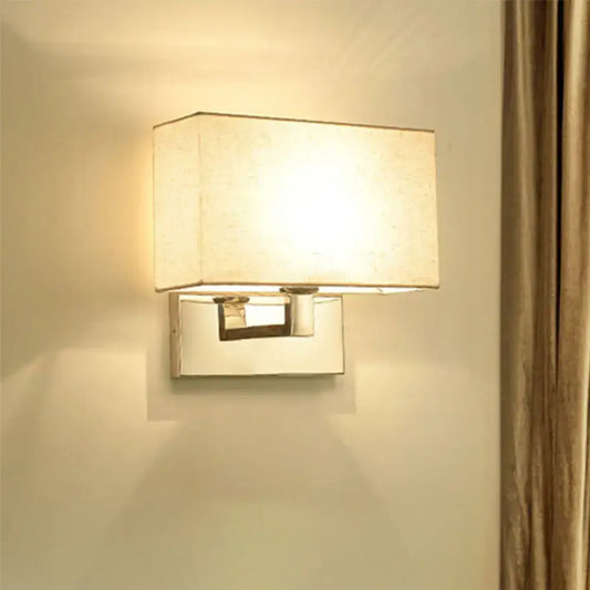 Modern wall light with sleek chrome finish and soft beige fabric shade measuring inches high and shade width