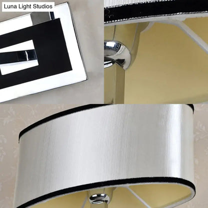 Modern chrome and beige oval wall sconce with a silver-finished table lamp and brushed metal shade with black trim