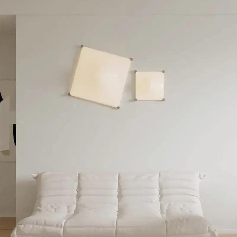Two minimalist chrome and glass decorbites bolla wall sconces with soft off-white diffusers for bedroom lighting