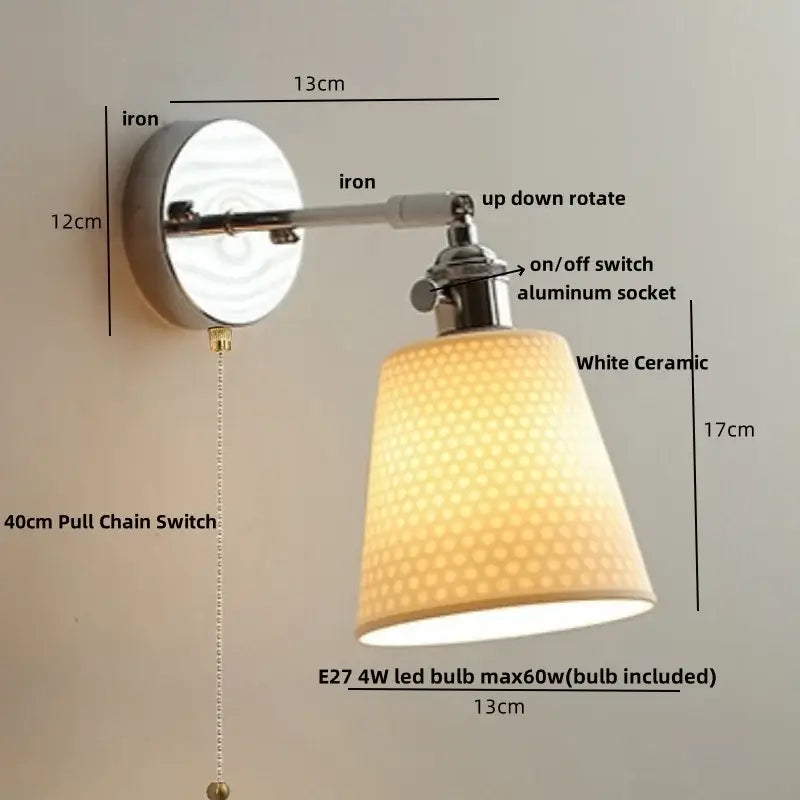 Modern chrome wall light fixture with sleek white ceramic lampshade and iron arm for bedroom use