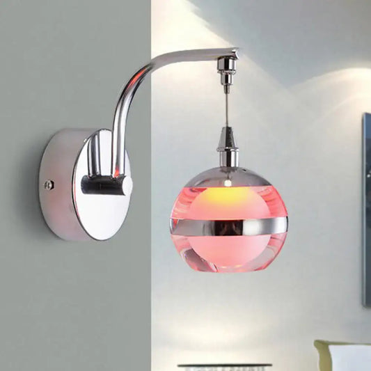 Modern chrome and pink glass wall sconce light featuring a sleek chrome finish and translucent pink glass globe lampshade