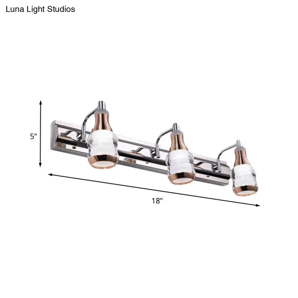 Modern chrome and rose gold vanity wall light with three frosted glass shades and sleek chrome finish for bathroom use